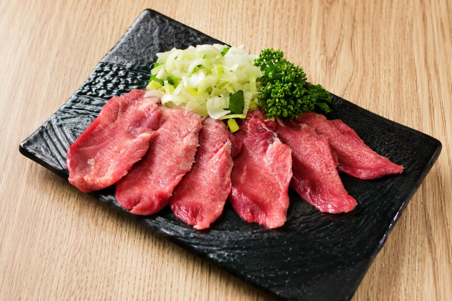 Negi Tan Shio (Tongue with Green Onion & Salt) - Thin-sliced tongue topped with green onion and salt sauce. A classic favorite
